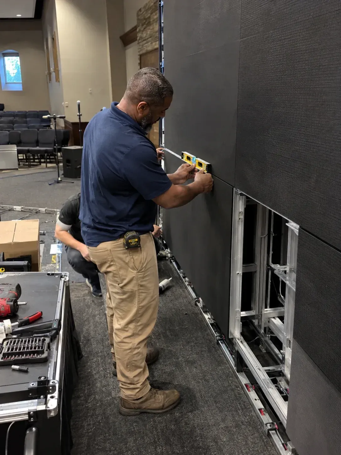 Technician aligning an LED module during display service